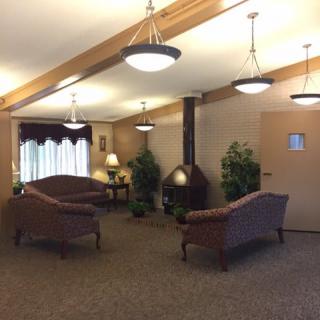 A cozy lobby area with sofas, warm lighting, and decorative plants.