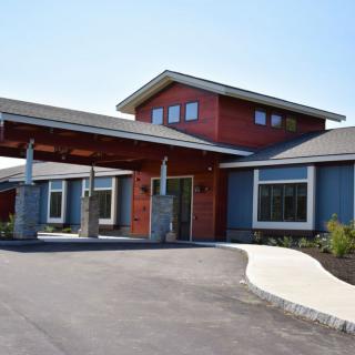 A modern building with a prominent entrance and sleek architectural design.