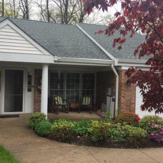 A cozy house with a well-maintained garden and inviting front porch.