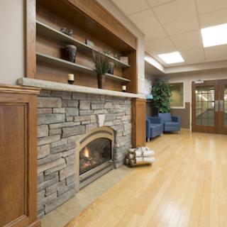 A cozy interior featuring a stone fireplace, wooden accents, and comfortable seating.