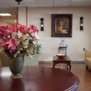 A cozy and inviting waiting area featuring a floral arrangement and artistic decor.