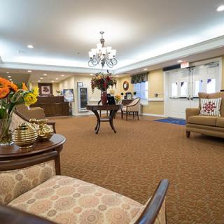A well-decorated lobby with comfortable seating and a central chandelier.