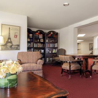 A cozy living room with comfortable seating and bookshelves.