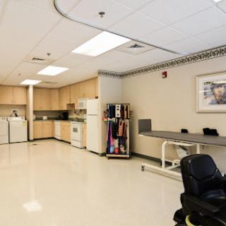 A clean and well-organized kitchenette area within a medical facility, featuring essential appliances and workspace.