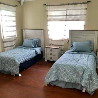 A cozy bedroom with twin beds and soft lighting.