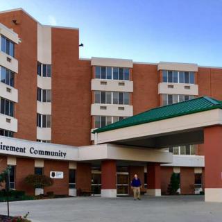 Entrance to a healthcare facility with brick exterior and covered drop-off area.