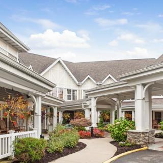 An inviting building entrance with well-maintained landscaping and a clear pathway.