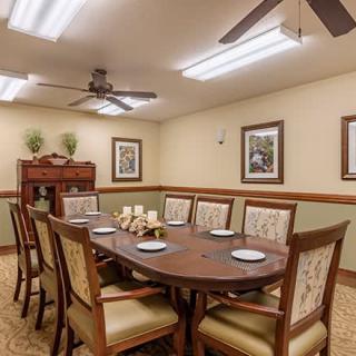 A well-decorated dining room with a large table and chairs.