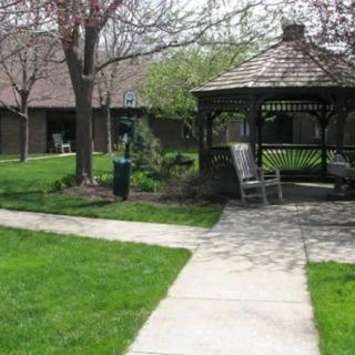 A tranquil garden with a gazebo and pathway.