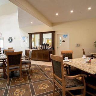 A cozy dining room setup featuring wooden furniture and warm lighting.