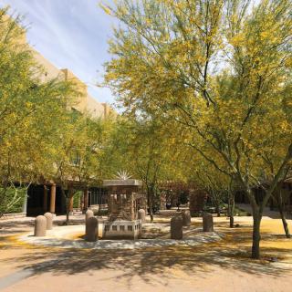 A peaceful park scene with trees and a central gazebo.