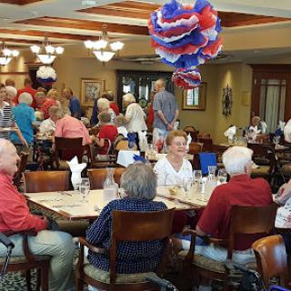 A lively community dining event with seniors enjoying their time together.