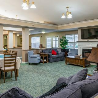 A spacious living room with comfortable seating, a television, and a dining area.