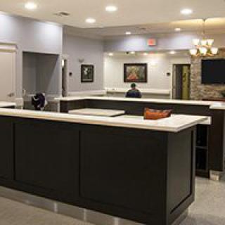 A modern reception area with a sleek counter and warm lighting.