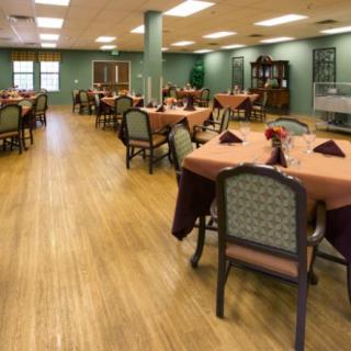 An elegantly set dining room with neatly arranged tables and chairs.