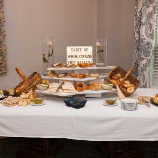 A beautifully arranged buffet table featuring an assortment of breads, pastries, and cheeses.