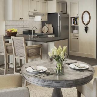 A modern kitchen and dining area with an open layout, featuring neutral tones and elegant table settings.
