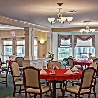An elegant dining room with neatly arranged tables and soft lighting.