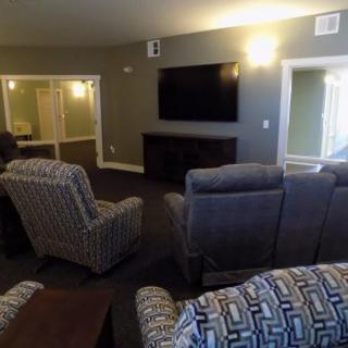 A cozy living room setup with comfortable chairs and a large TV.