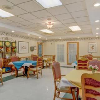 Bright and cozy dining room with neatly arranged tables and chairs.