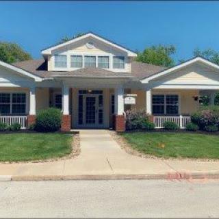 A suburban house with a well-maintained lawn and driveway.
