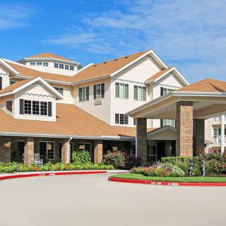 A modern residential building with landscaped surroundings.