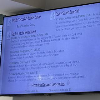 A television displaying a menu with various food options.