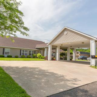 A welcoming residential building with a spacious driveway and well-maintained landscape.
