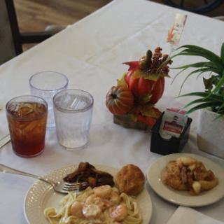 A cozy dining table showcasing a delicious meal and refreshing drinks.
