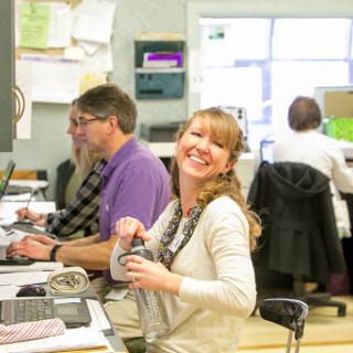 A cheerful office atmosphere with team members engaged in their work.