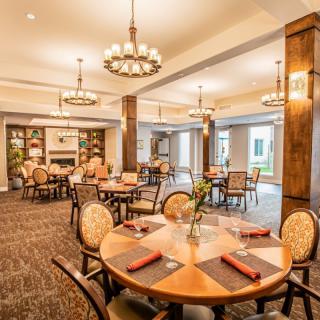 A beautifully decorated dining room with elegant lighting and well-arranged tables.