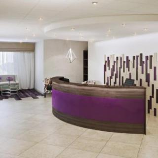 A modern reception area with a curved desk and stylish decor.