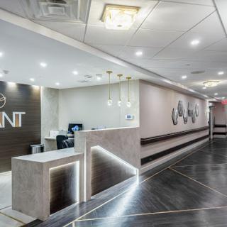 A modern office reception area featuring sleek design and ambient lighting.