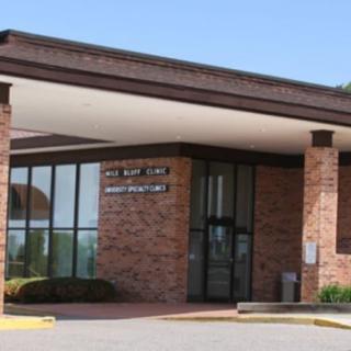 Entrance to a brick building with large windows.