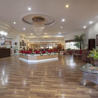 A spacious hotel lobby with elegant lighting and contemporary decor.