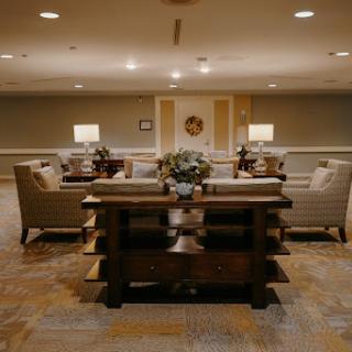 A warm and inviting living room setup featuring comfortable seating arrangements and soft lighting.
