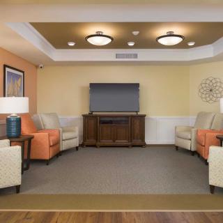 A cozy living room with comfortable seating and a large television.