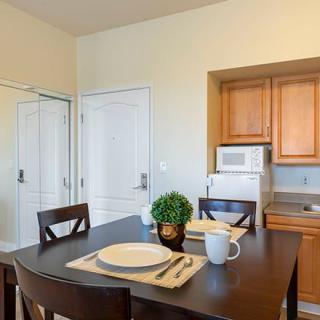 A minimalist kitchen and dining area with a neatly set table.