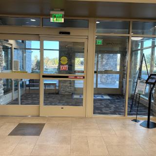 A view of the entrance area featuring automatic glass doors and an inviting lobby space.