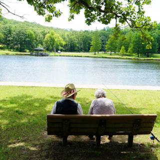 Two individuals enjoying a peaceful moment by the lake.