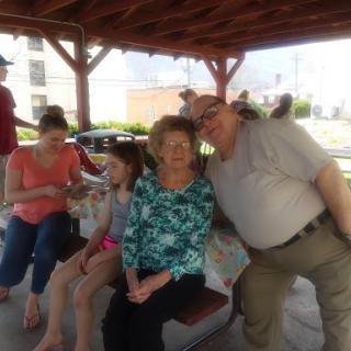 A joyful family gathering under a gazebo, enjoying each other's company.