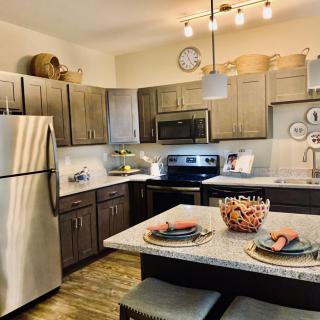 Modern kitchen with stainless steel appliances and a cozy dining setup.