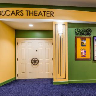 Entrance to a theater with colorful walls and movie posters.