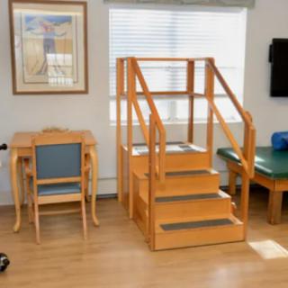 A therapy room featuring a small staircase used for rehabilitation exercises.