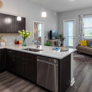 A modern open-concept kitchen and living room with stylish decor.