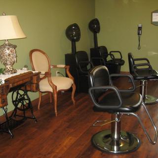 A cozy hair salon with vintage decor and modern styling chairs.