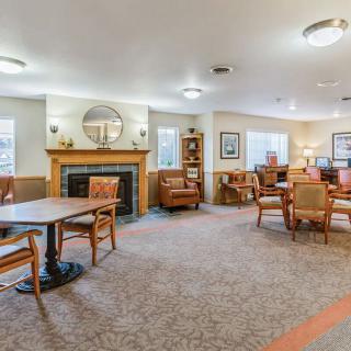 A cozy living room interior with comfortable seating and a fireplace.