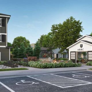 A modern building with a landscaped area and accessible parking spaces.