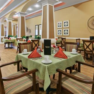 A well-decorated restaurant interior with neatly set tables and chairs.