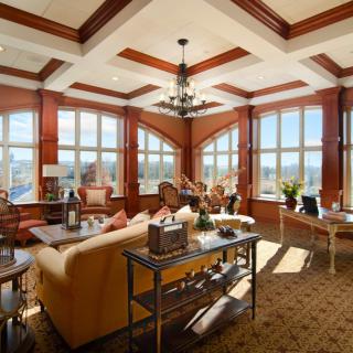 A spacious and elegantly designed living room with large windows allowing natural light to fill the space.